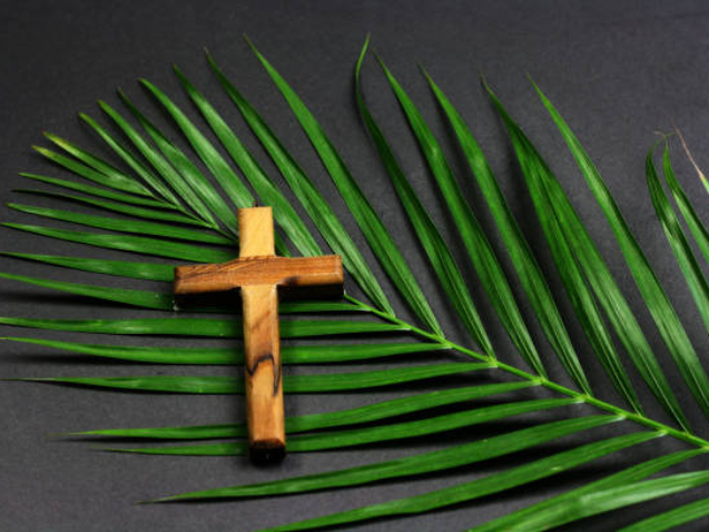 Easter wooden cross on black background , religion Palm Sunday concept